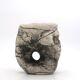 Ceramic vase sculpture decorated with faces and featuring a hole, 1980s.