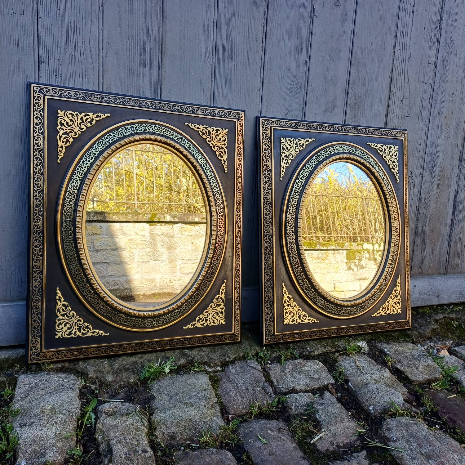 Pair of antique mirrors from the Napoléon III period, black and gilded.
