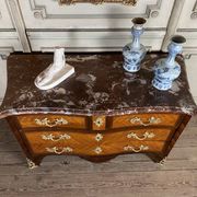 Louis XV style commode in rosewood and palisander veneer, gilt bronze mounts, and Rance marble top.