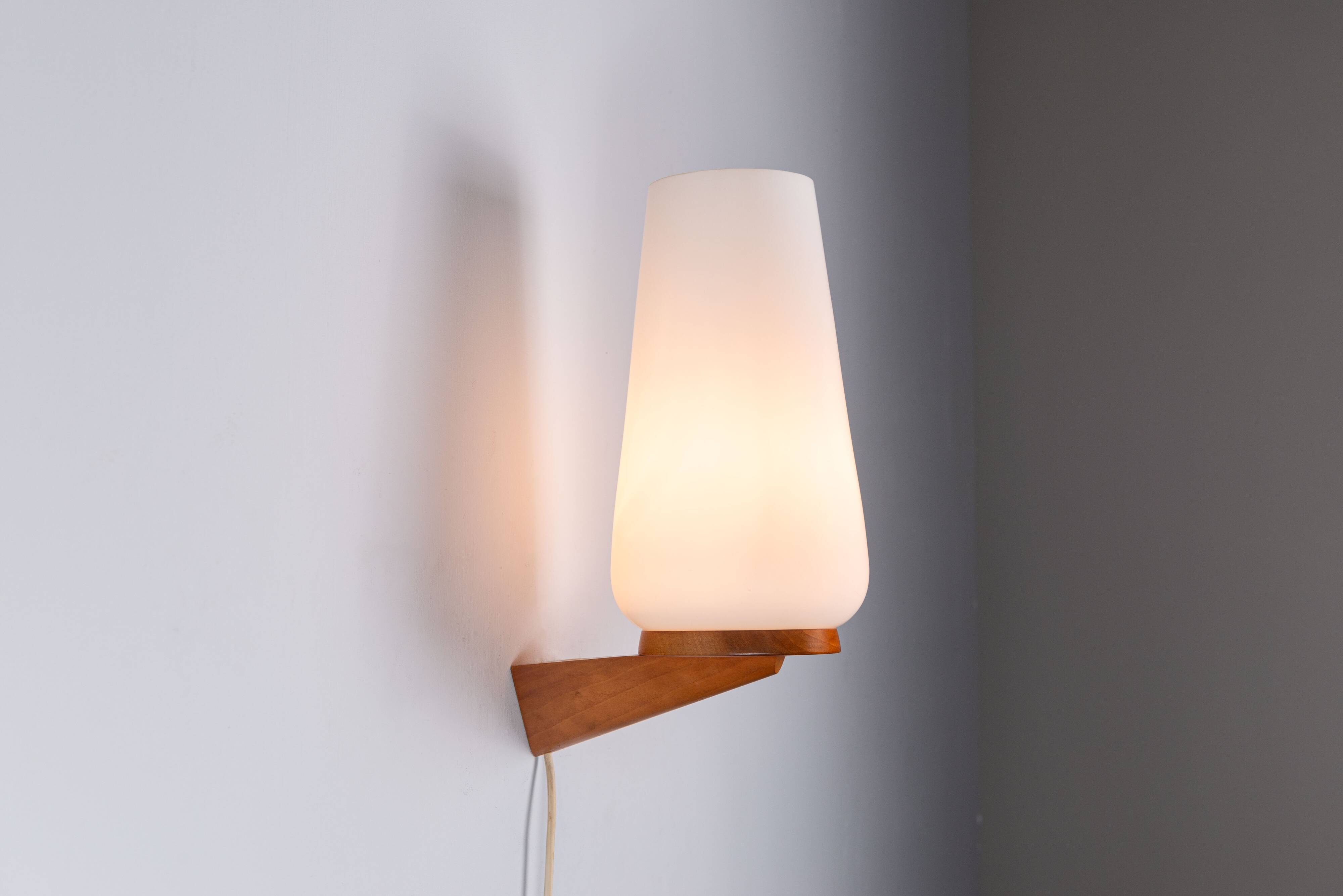 Wall lamp with opal glass shade on wooden base by Philips