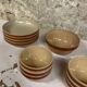 Lot of vintage Gien stoneware from France, 14 pieces including bowls and salad plates.