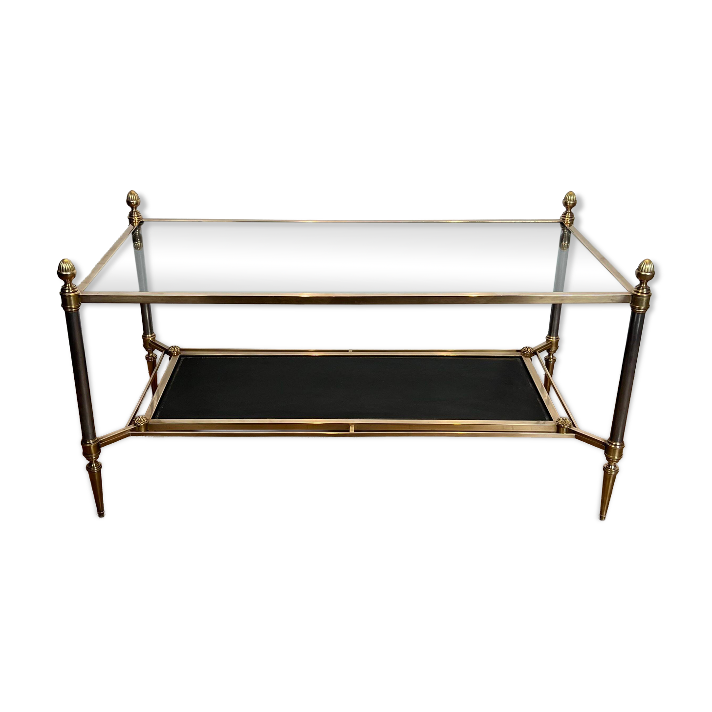 Brass coffee table with a black leather top and golden edges from Maison Jansen.