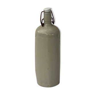 Old enamelled wading bottle and porcelain cap