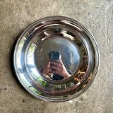 Round, hollow silver-plated metal dish