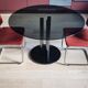Round black smoked glass dining table + 2 terracotta chairs