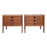 Pair of vintage Scandinavian bedside tables, three drawers, honey-toned wood.