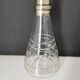 Crystal bottle with silver metal neck rim