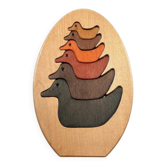 Vintage wooden puzzle with duck figurines.
