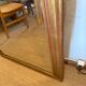 Grand miroir ancien en bois patiné doré