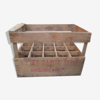 Old crate has wooden bottles advertising