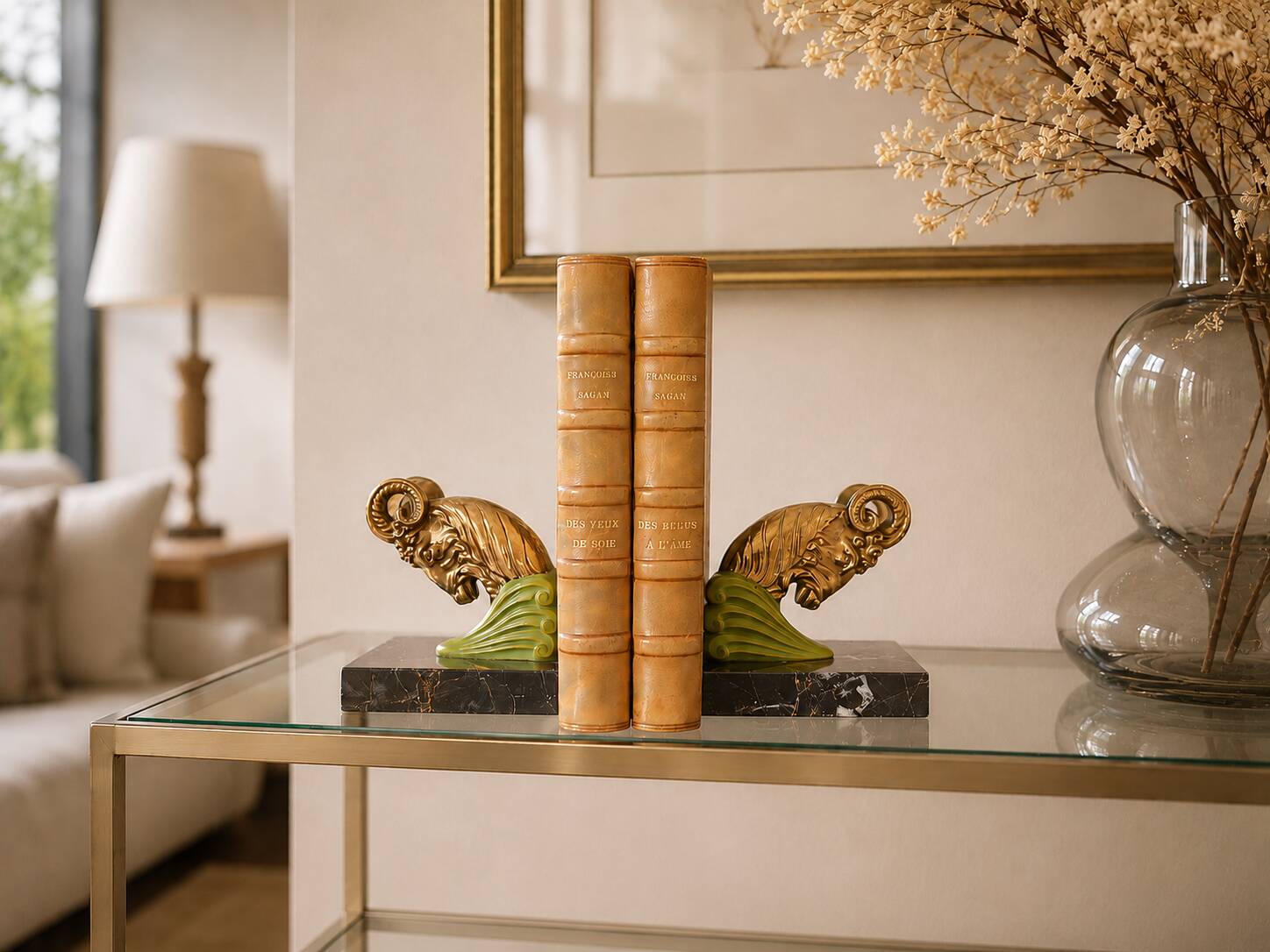 Art Deco pair of bookends with ram's heads, patinated metal and black marble.