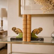 Art Deco pair of bookends with ram's heads, patinated metal and black marble.