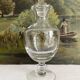 Antique stemmed blown glass bottle with engraved medallion