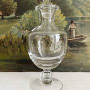 Antique stemmed blown glass bottle with engraved medallion