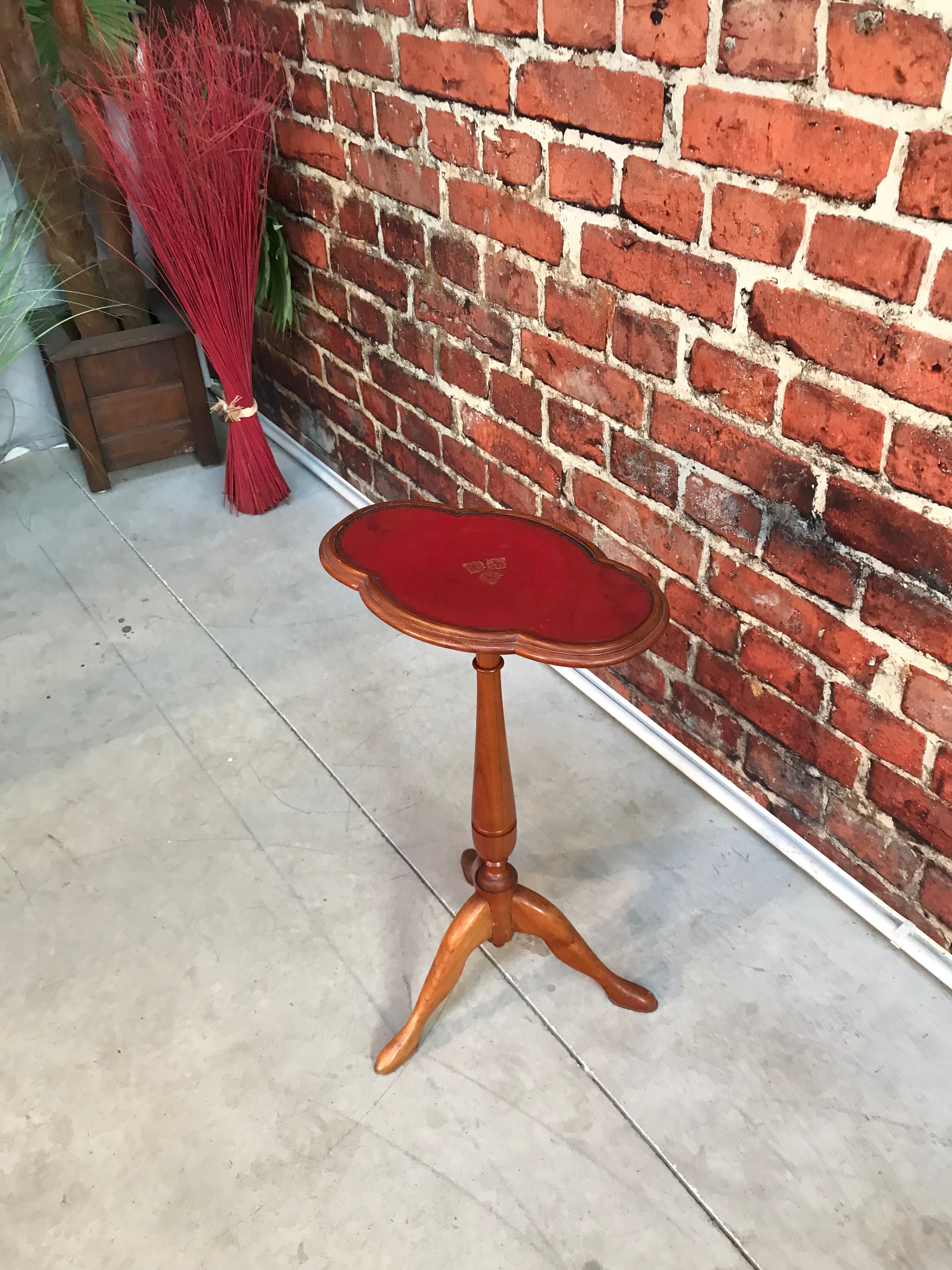 Wooden pedestal table red leather top