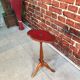 Wooden pedestal table red leather top