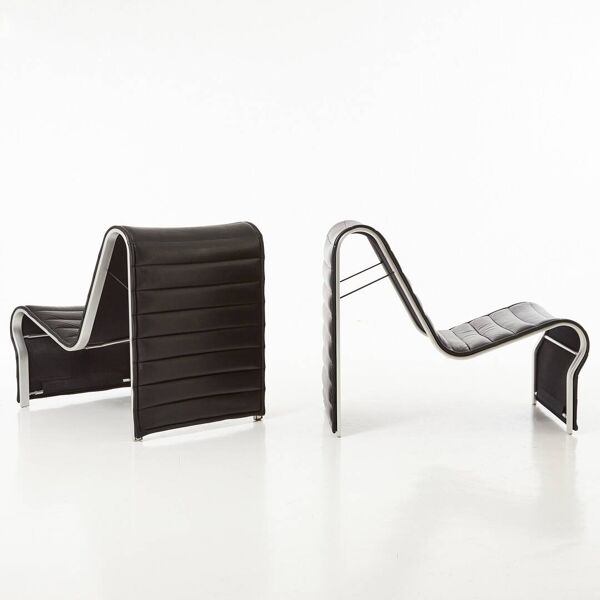 Modern black leather lounge chairs with an aluminium frame.
