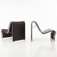 Modern black leather lounge chairs with an aluminium frame.