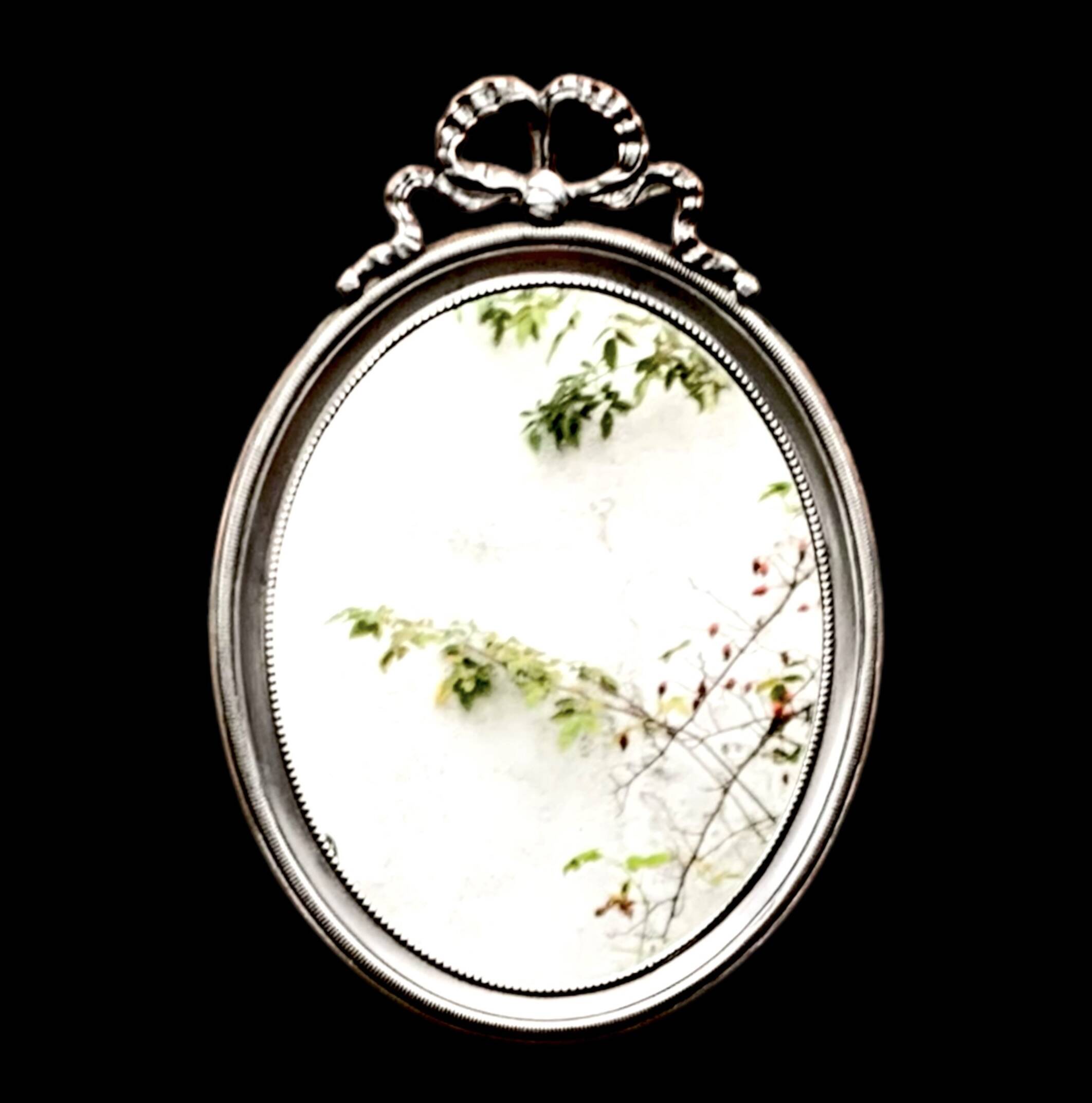 Louis XVI style oval metal wall mirror