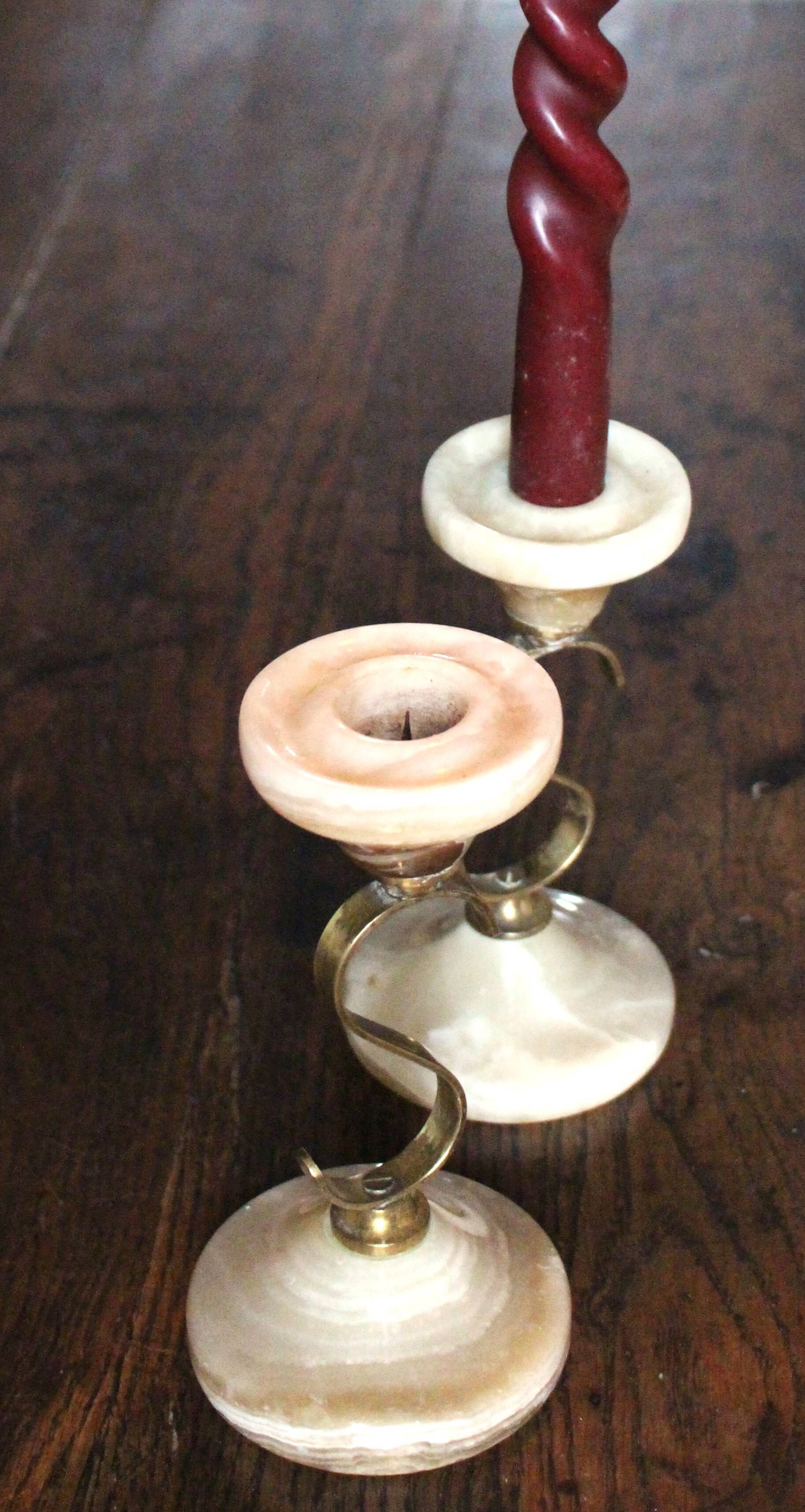 Pair of curved brass candlesticks with onyx