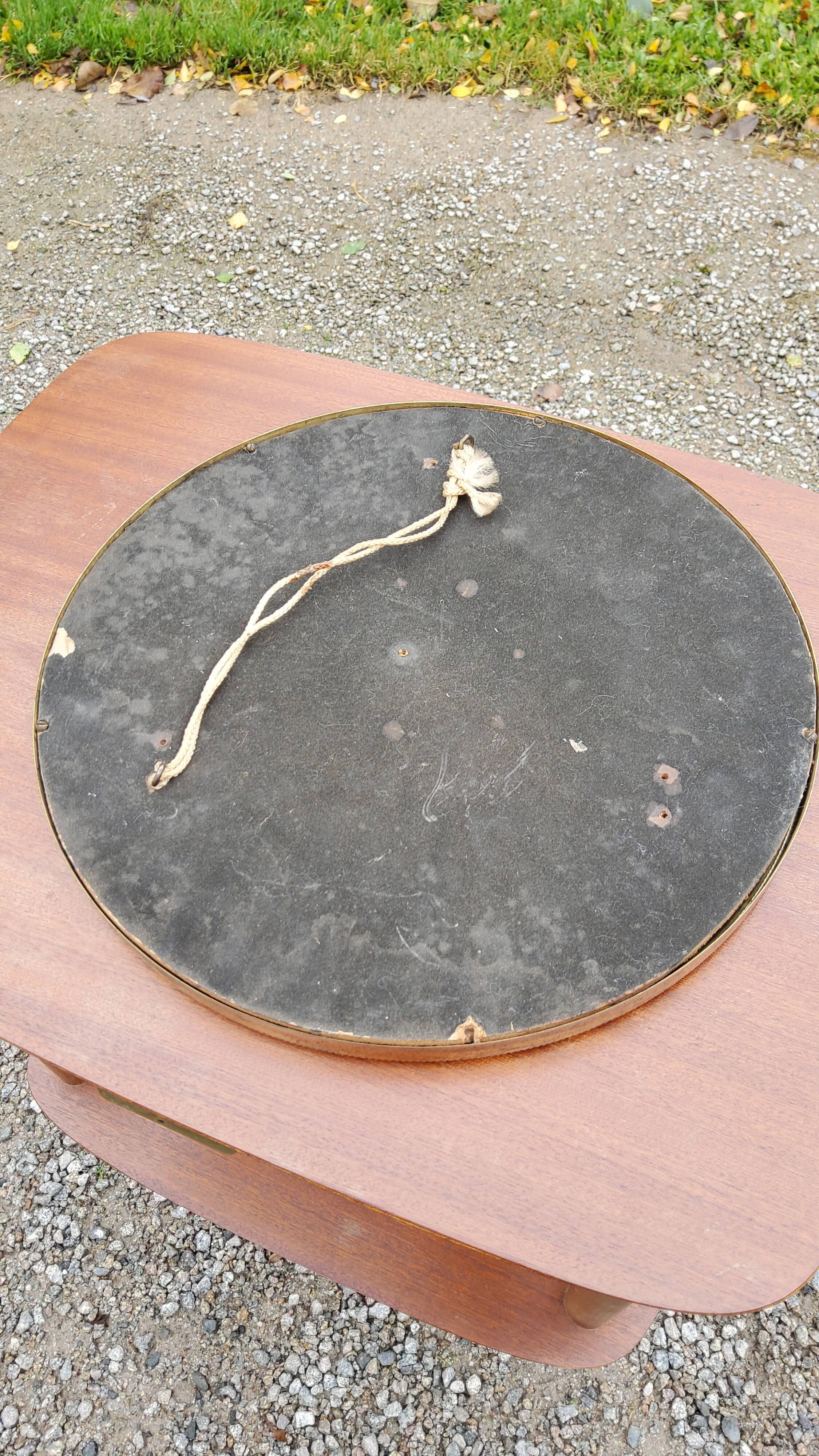 Round mirror of the 50s in gold metal 33cm in diameter