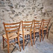 Set of 4 mid-century Italian dining chairs with woven seats, circa 1950–1970.