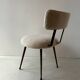 Low seat in metal and white boucle fabric.