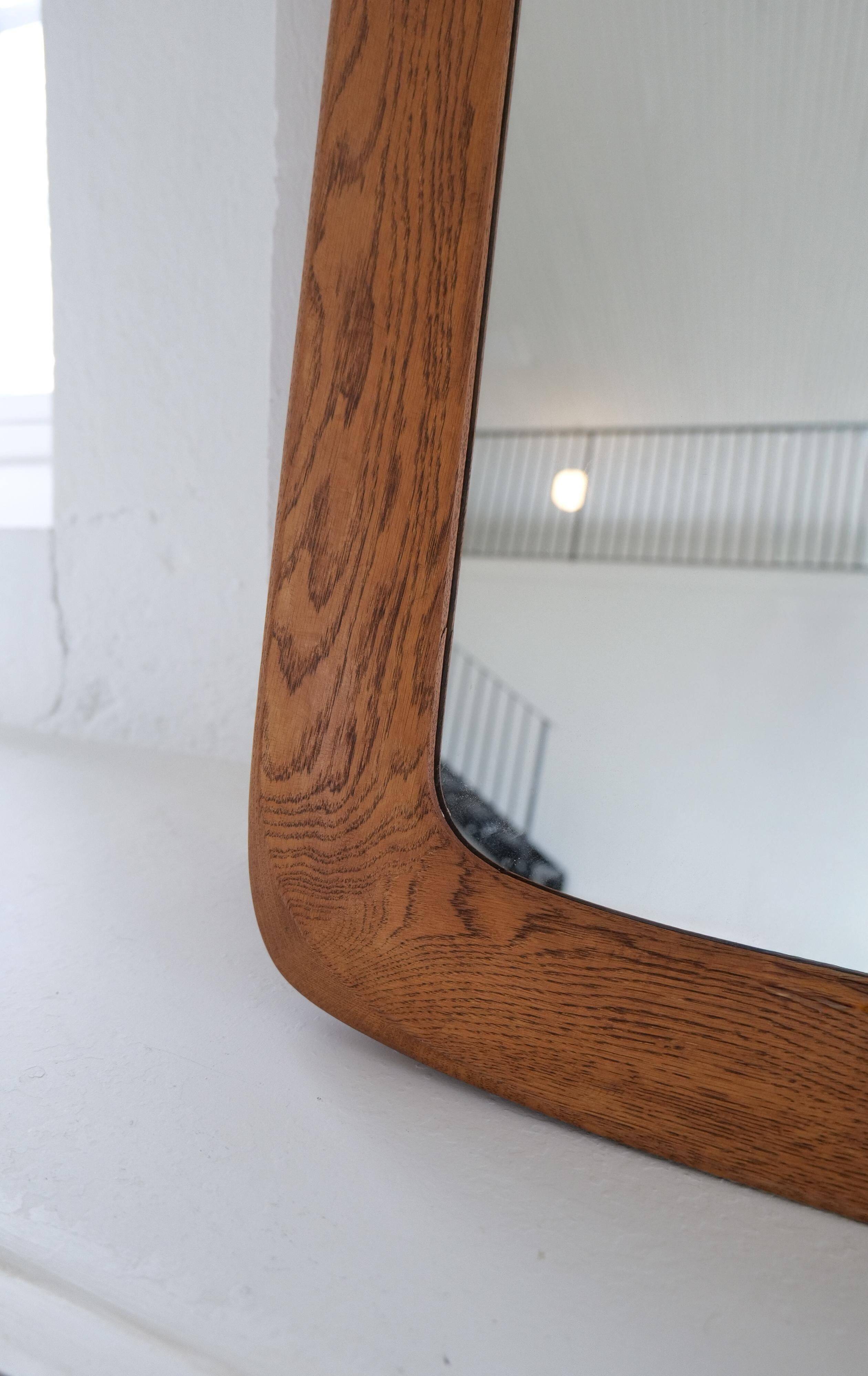 Mid-century modern sculptural wall mirror in stained oak, glass, Glas & Trä 1959
