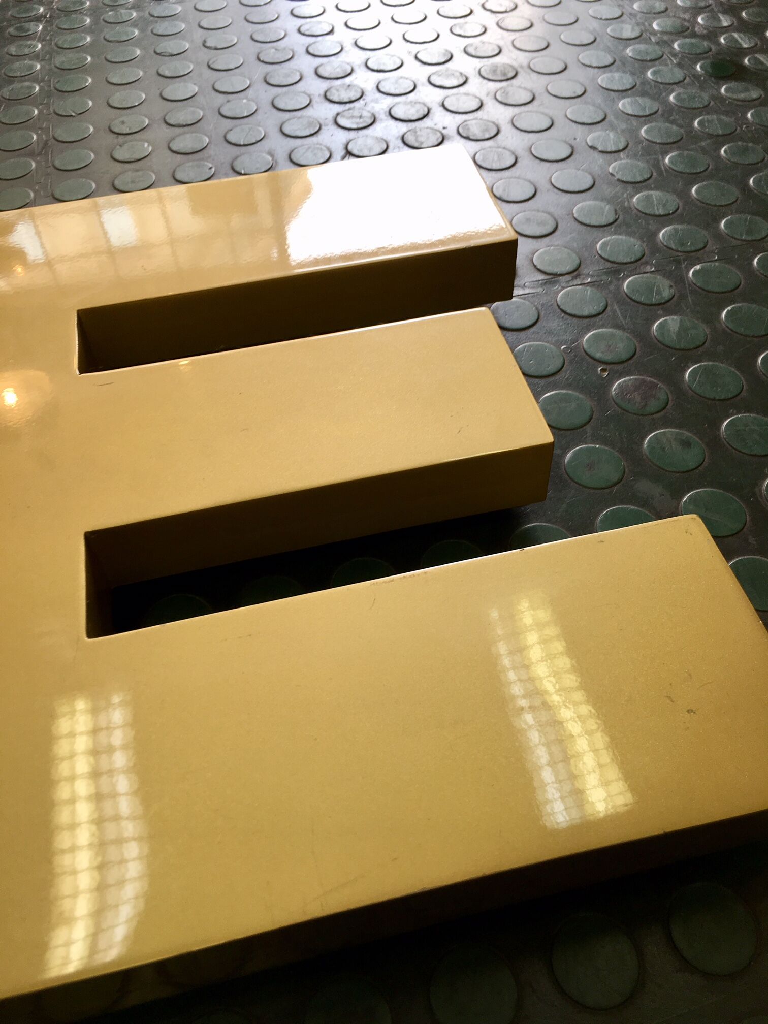 Golden sign letter E