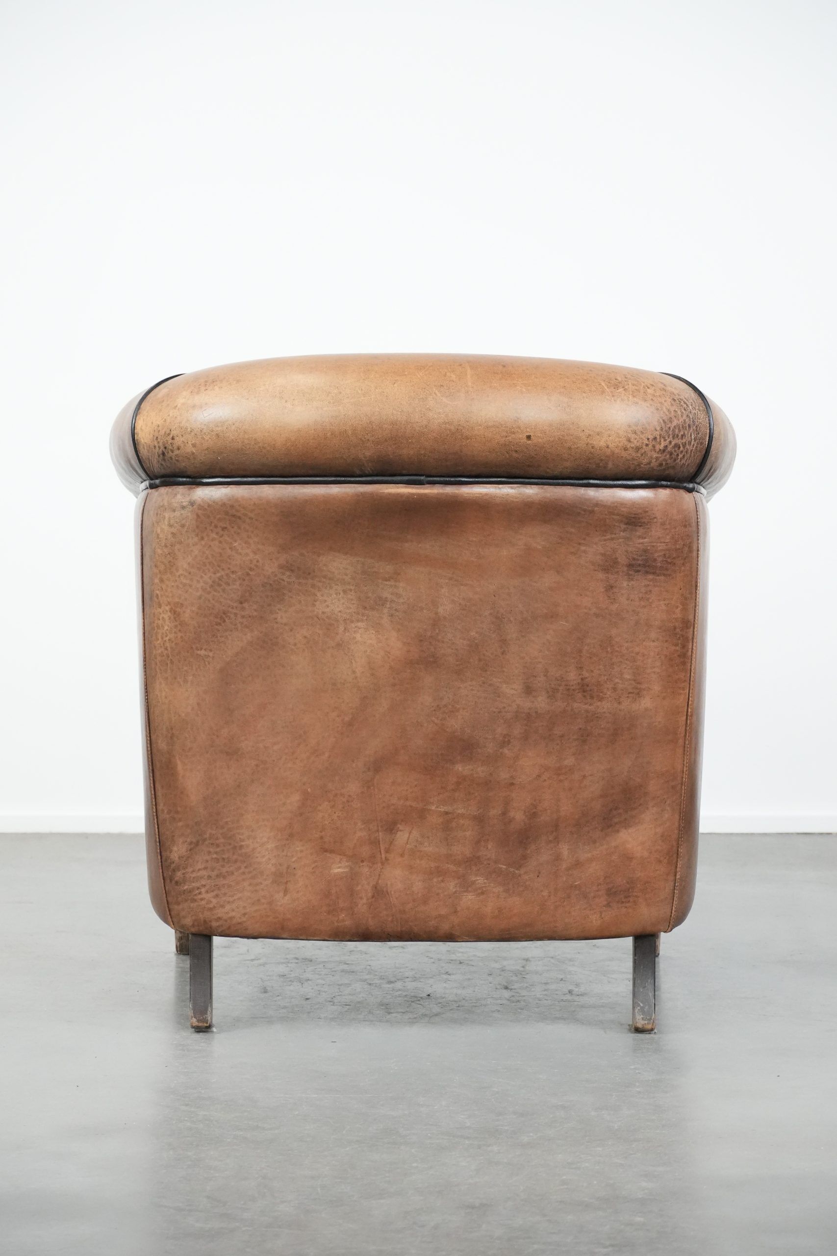 Sturdy vintage sheepskin club armchair with a beautiful patina