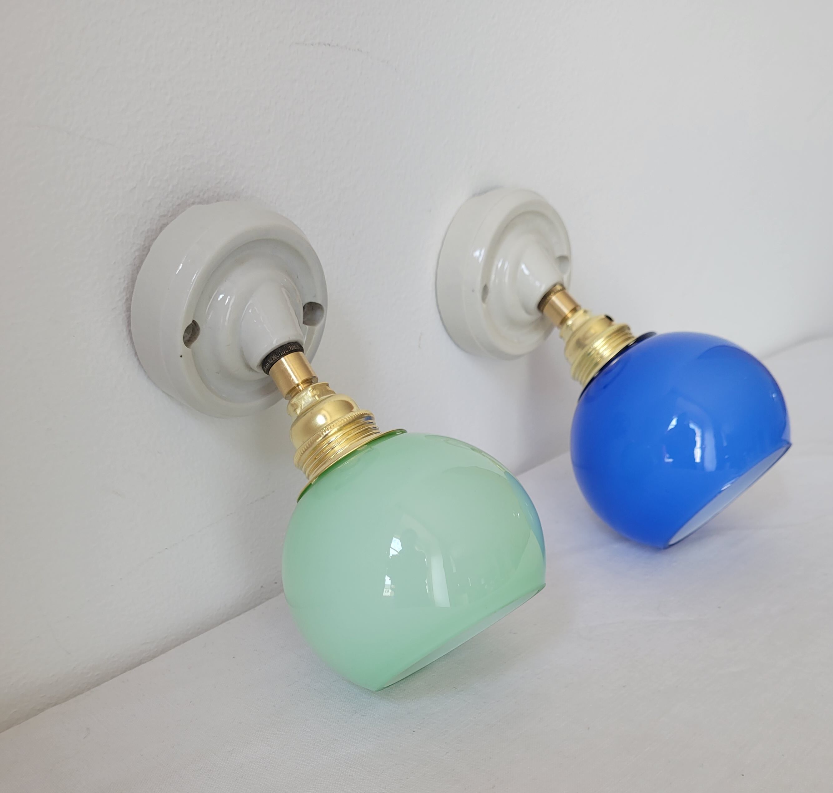 Duo of porcelain and opaline wall lamps