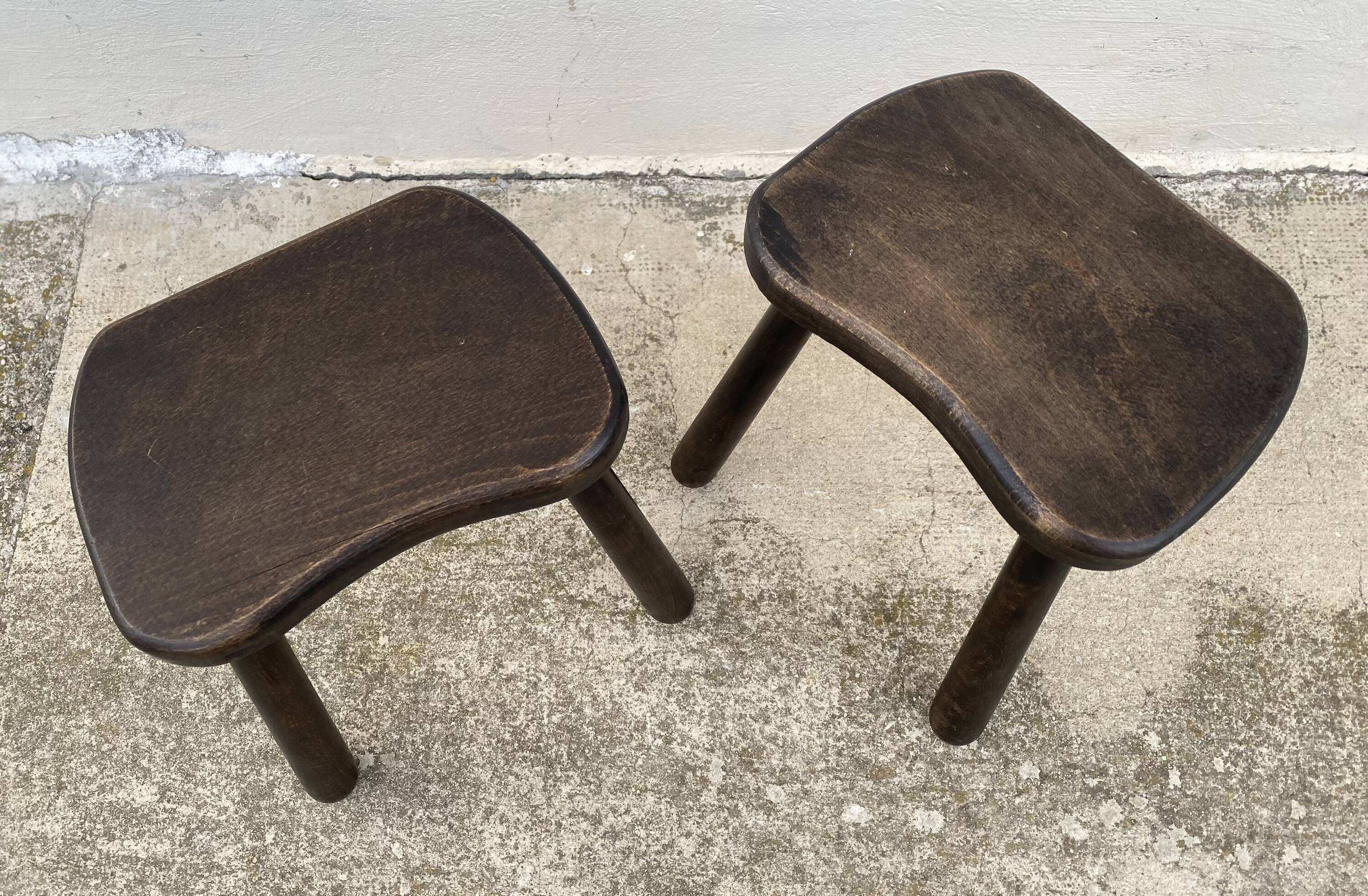 Pair of vintage stained wood tripod stools from the 1970s