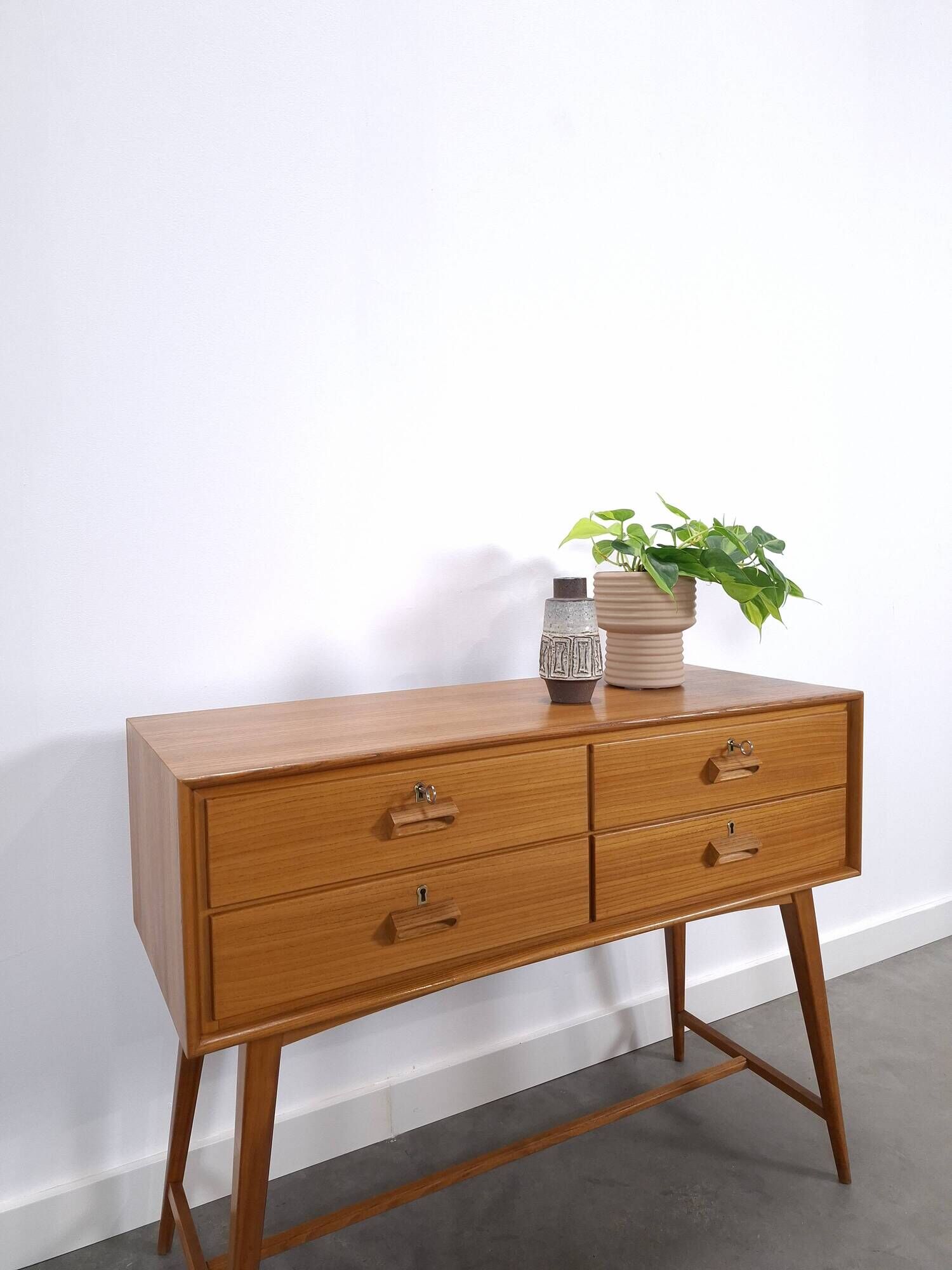 Vintage teak Danish chest of drawers with high slanted legs, side table, sideboard.