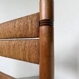 Brutalist style bed with chain and straw