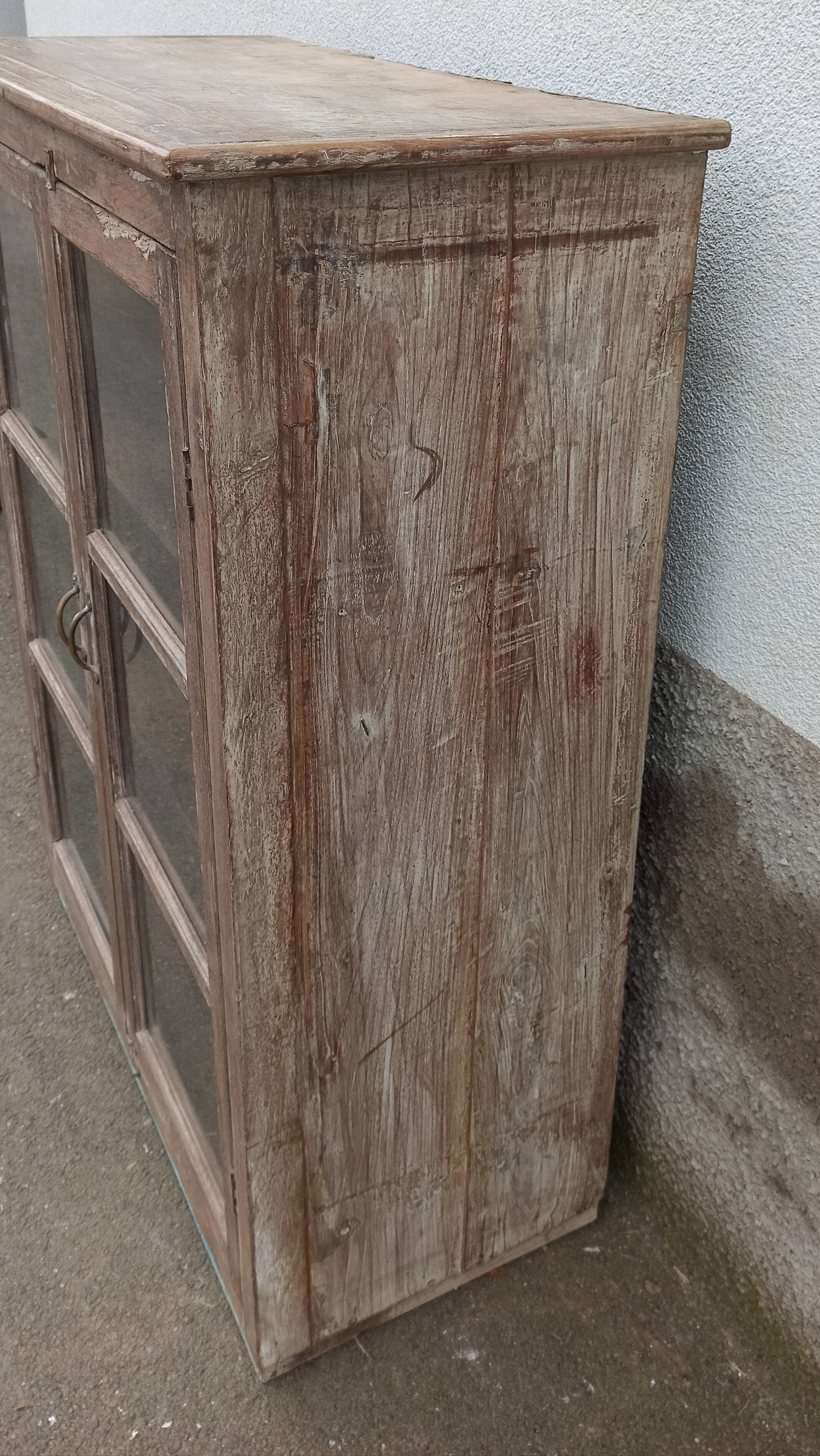 Old glazed wooden cabinet with metal bottom