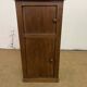 Old small storage unit with sliding and hinged doors.