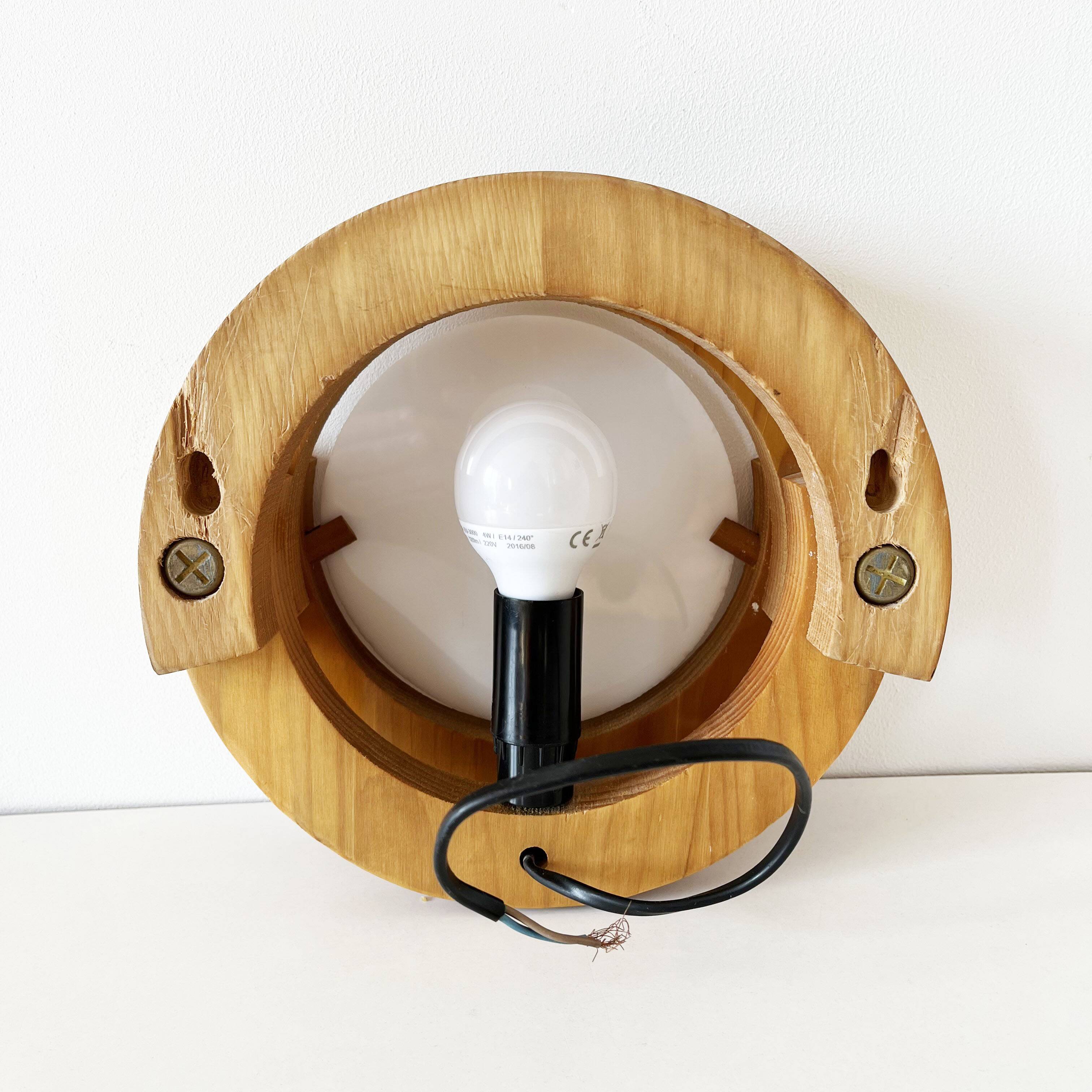 Round pine and plexiglass wall light, 1970s
