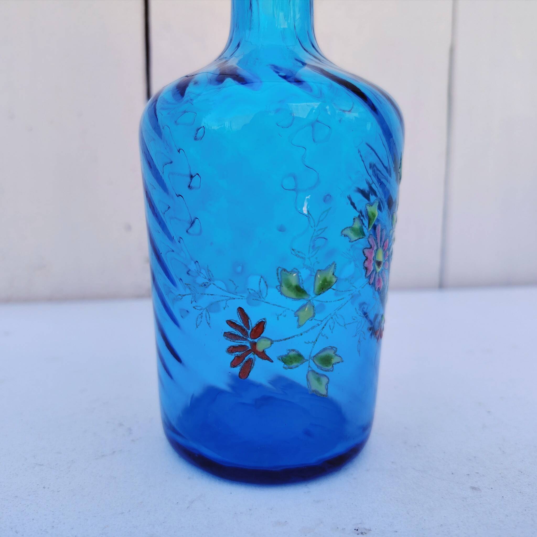 Vintage twisted blue glass carafe with enamel decoration.