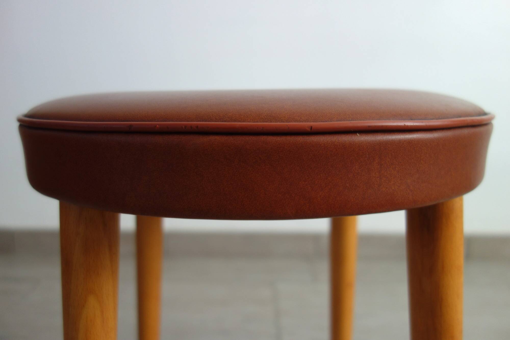 Baumann low stool from the 60s in brown leatherette