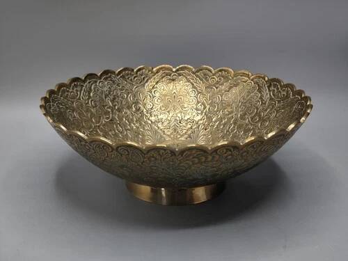 Engraved brass bowl from the mid-20th century with a scalloped edge.