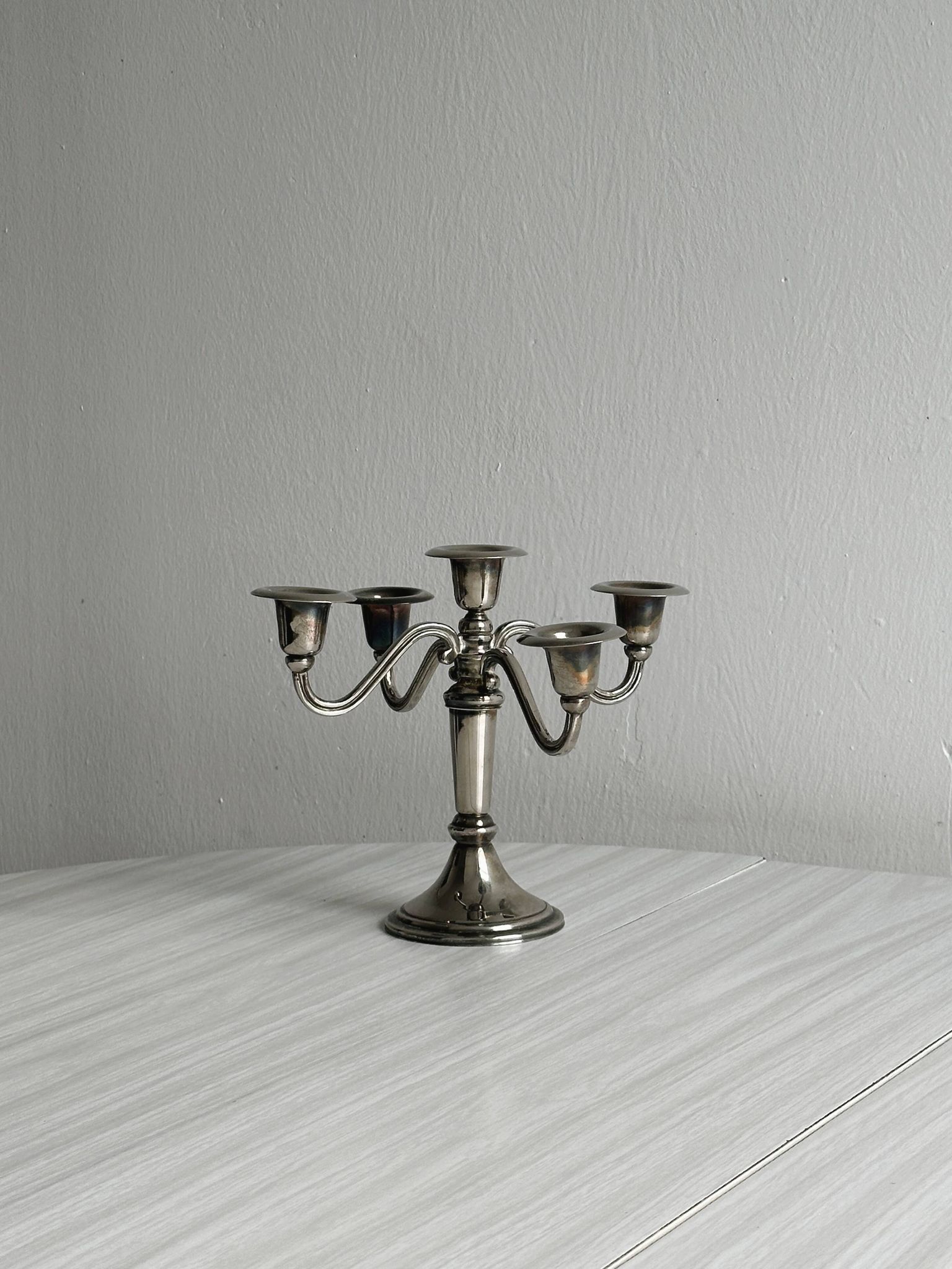 Candlestick candle holder in patinated silver metal