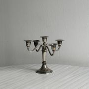 Candlestick candle holder in patinated silver metal