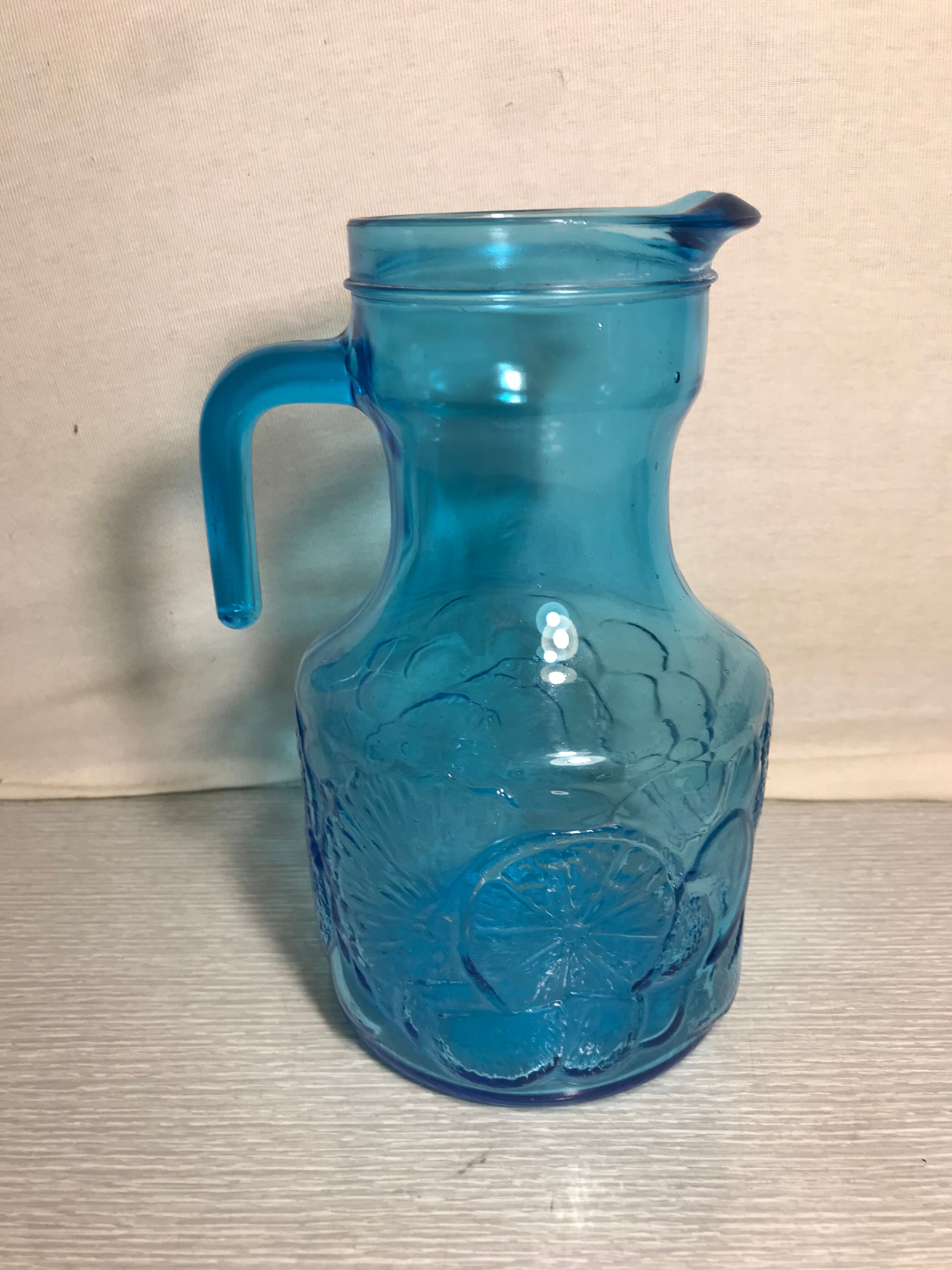 Blue moulded pitcher with decorative handle