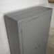 Curved wardrobe workshop locker made of wood repainted in grey.
