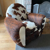 Pair of club chairs covered in cowhide
