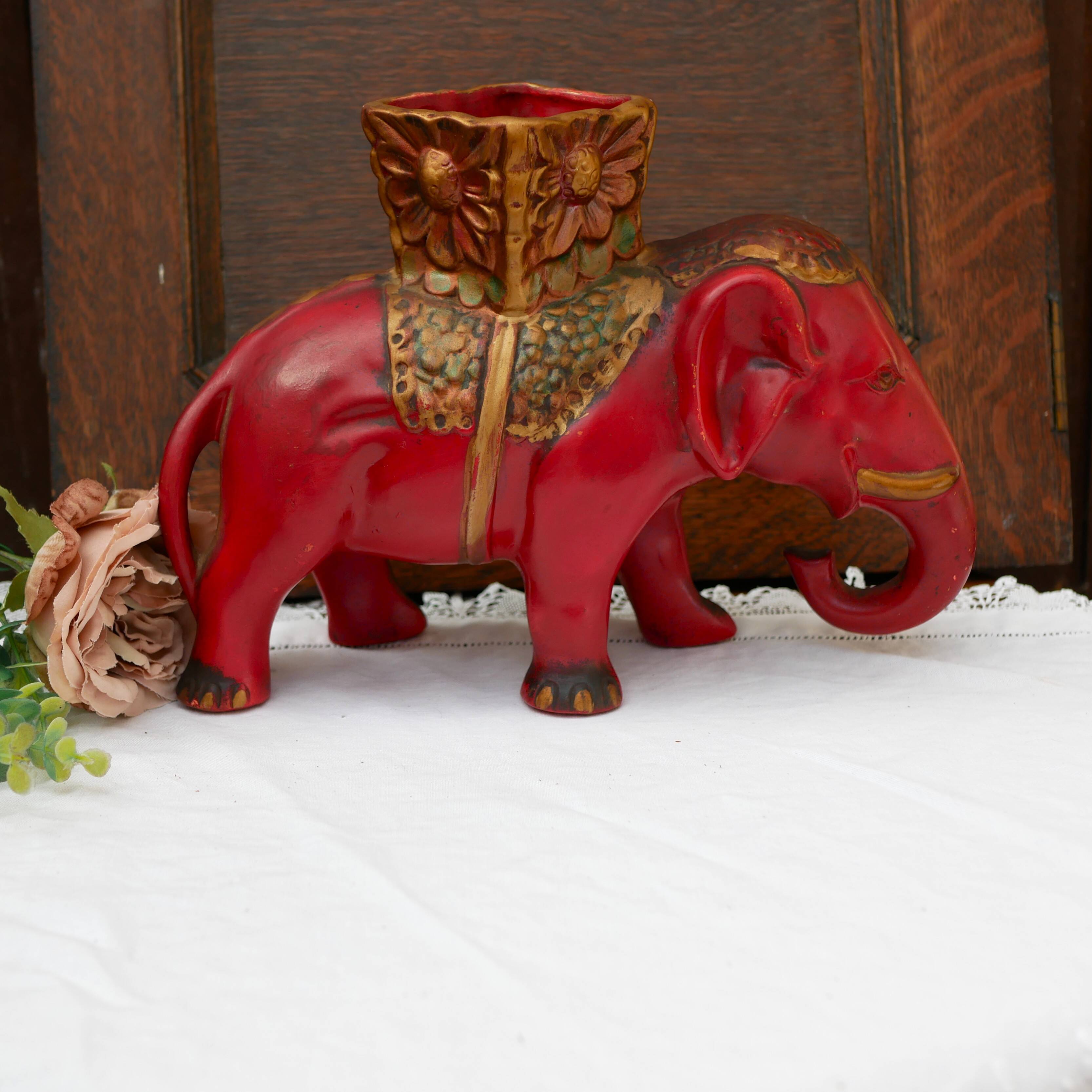 A pair of red and gold ceramic vases in the shape of elephants, 1940s.