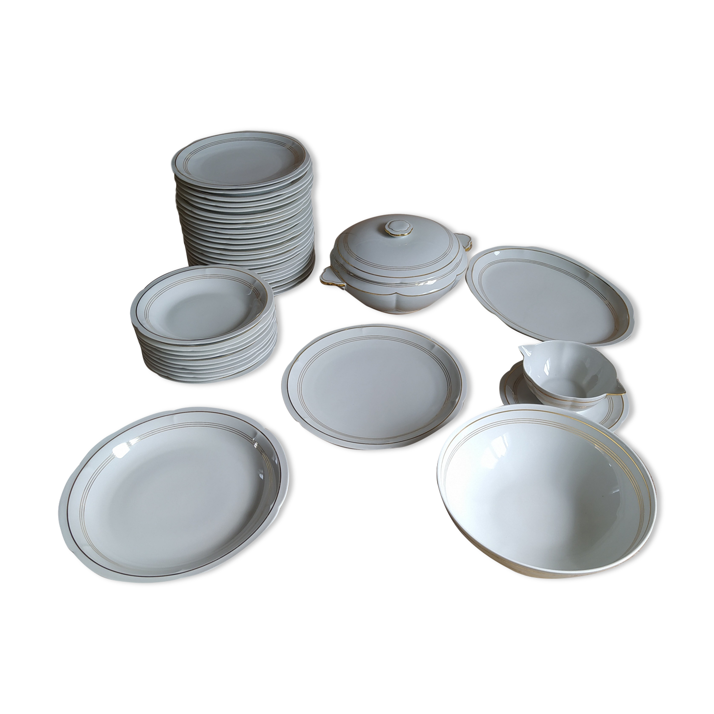 White Limoges porcelain table service with gold trim.