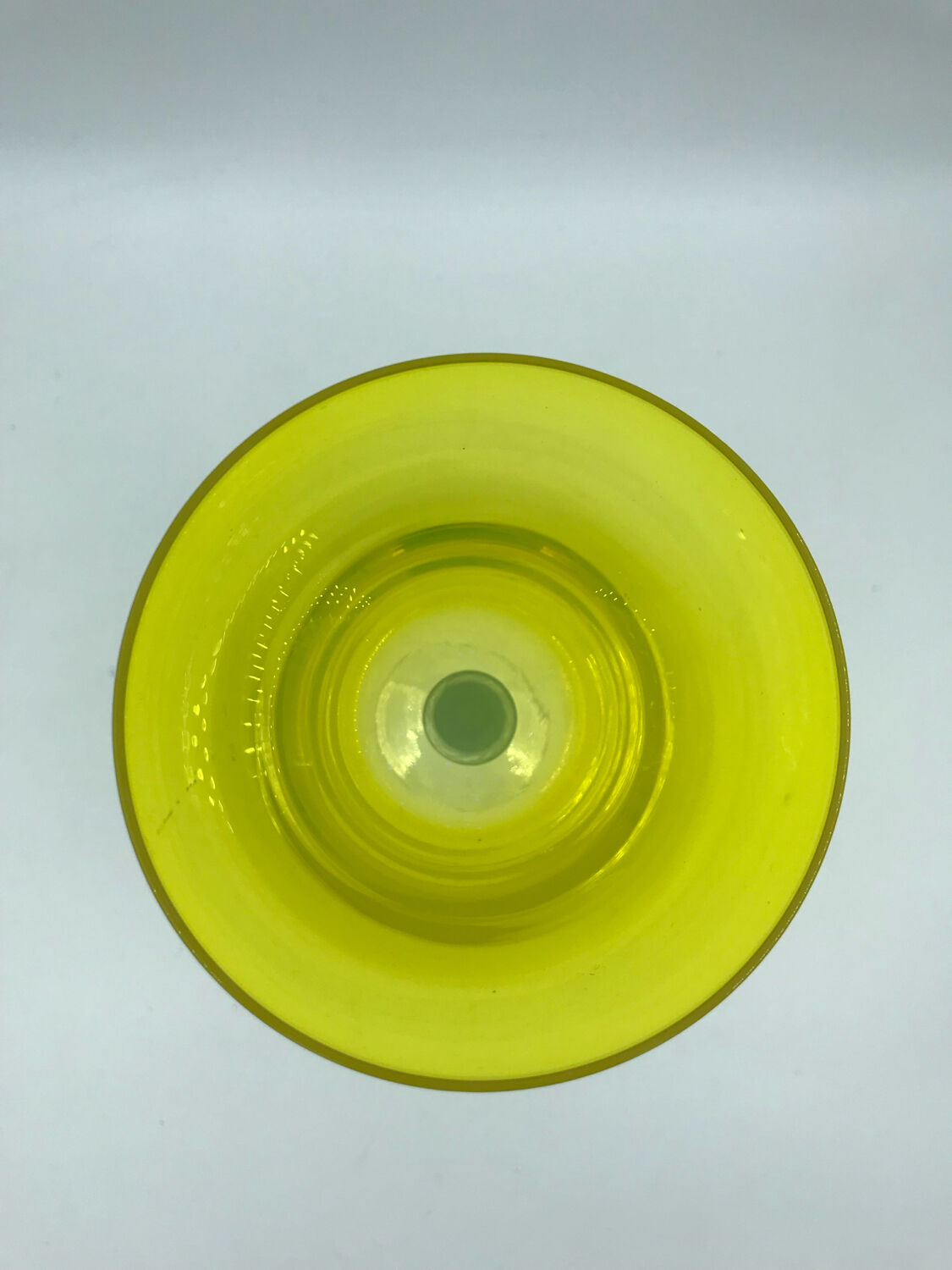 Yellow glass candlestick on a stand