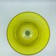 Yellow glass candlestick on a stand