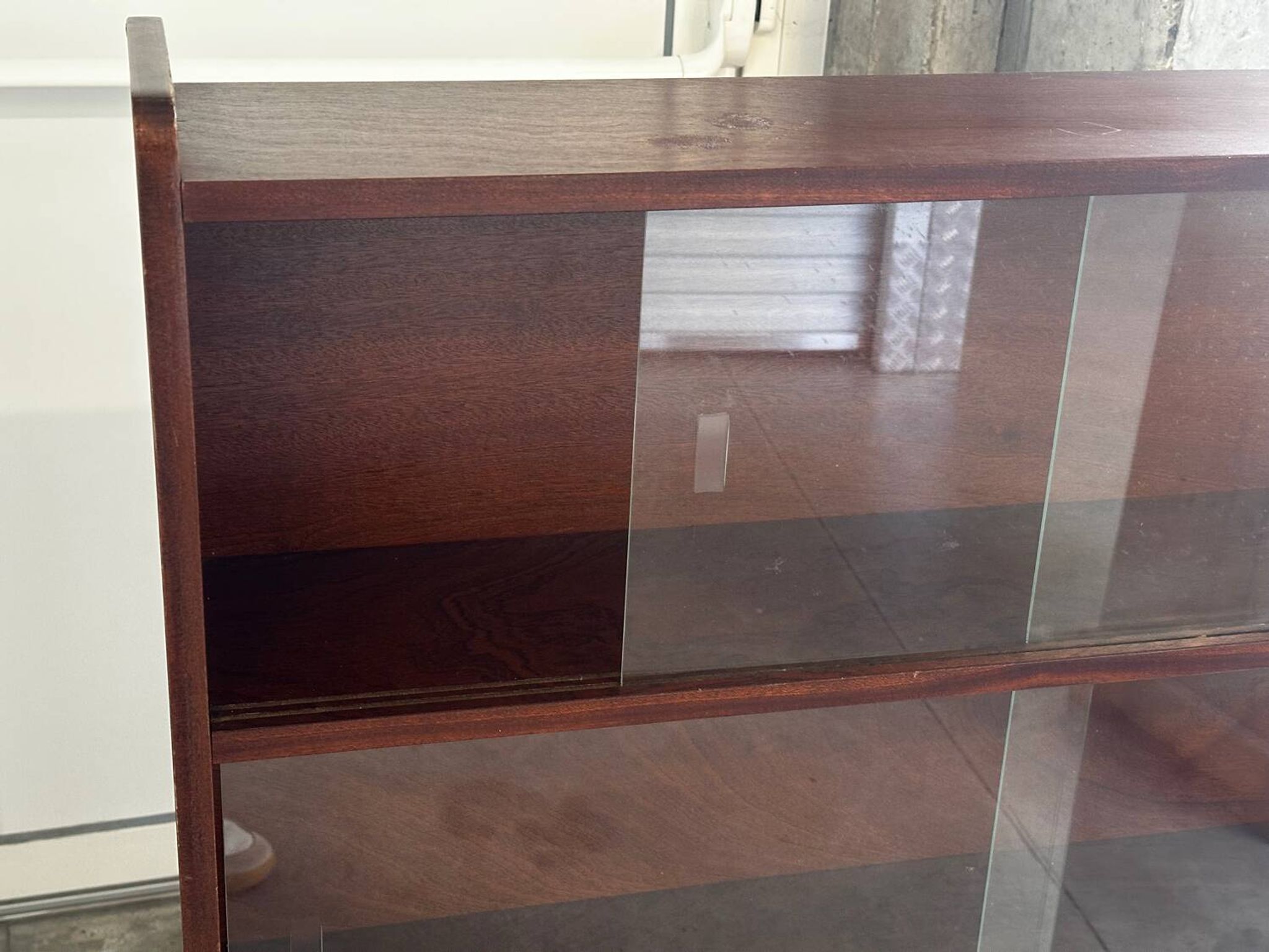Vintage 1960s wooden library with sliding doors.